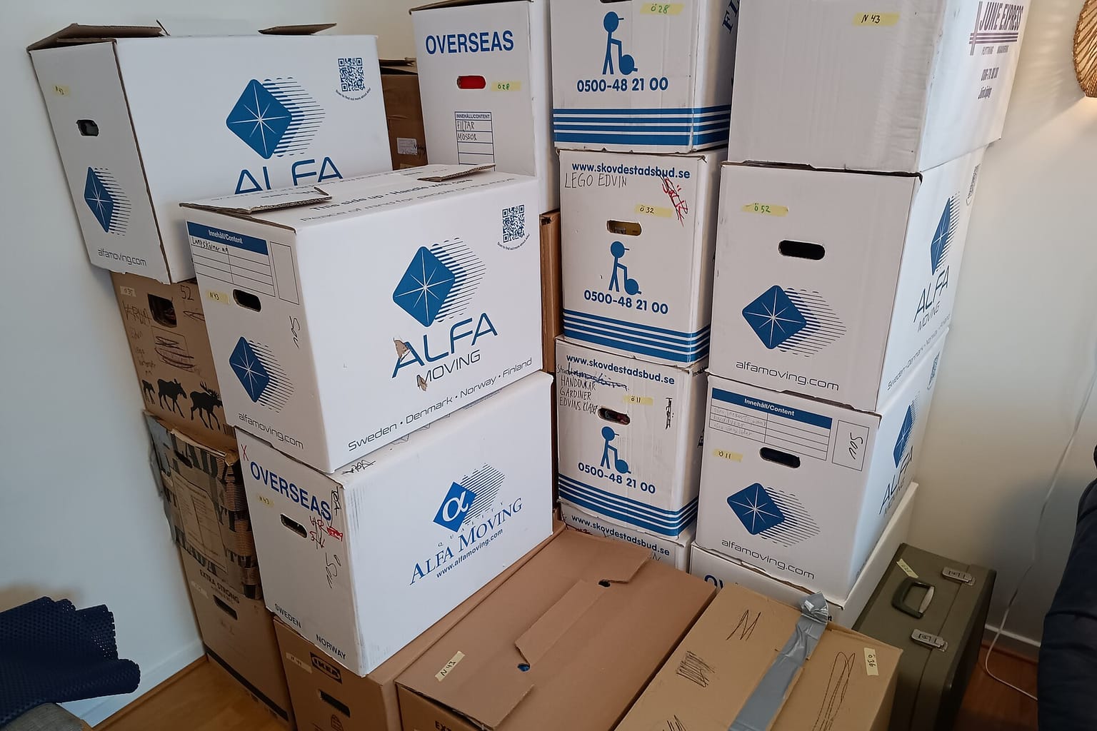 Boxes and bags staged by a doorway during a home cleanout